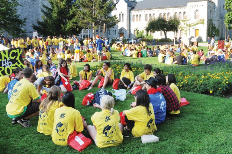 Queen's students gather into themed groups during Frosh Week.
