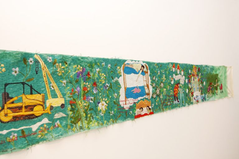 Rebecca Soudant’s husband created the metal-scrolling device that kept her tapestry intact.