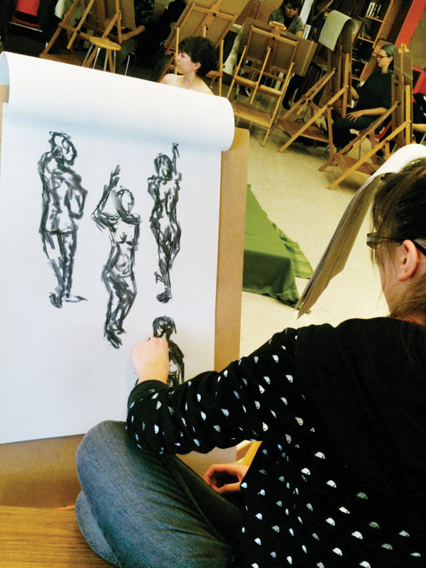 A student in the Art & Design Foundation Program at Loyalist College sketches undraped model Bonita Summers.