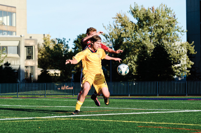 Winger Andrew Colosimo holds off a Royal Military College player during the Gaels' 1-0 win at Tindall field on Saturday.