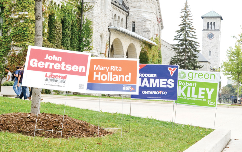 Local candidate lawn signs on display outside Ontario Hall on Queen's Campus