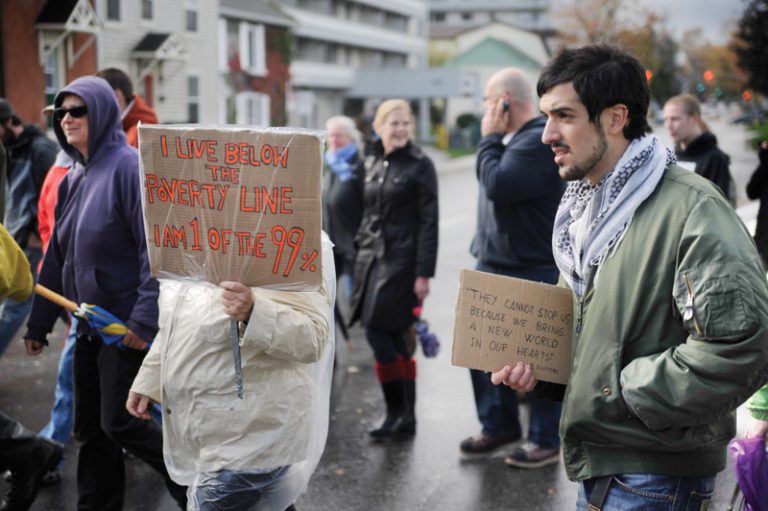 Queen’s exchange student Antonio Cillero of Spain was one of approximately 20 protesters who marched on Princess Street on Saturday as part of the Occupy Kingston movement.