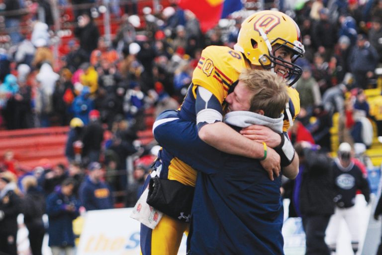 Backup quarterback Ryan Mitchell celebrates with injured starter Billy McPhee during the football team's 14-10 OUA quarter-final win at Richardson Stadium on Saturday.