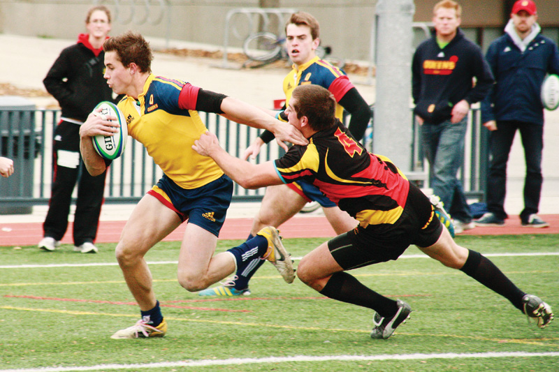 OUA top scorer Liam Underwood breaks a tackle during the men's rugby team's 34-0 win over the Guelph Gryphons on Saturday.