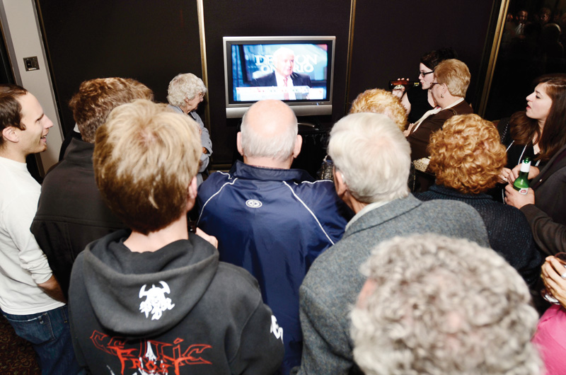 Supporters gather around the TV at John Gerretsen's campaign office in Kingston on Oct. 6.