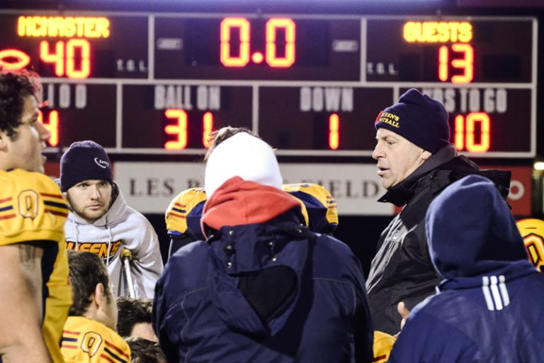 Head coach Pat Sheahan (back right) talks to his team after Saturday's loss. In nine seasons