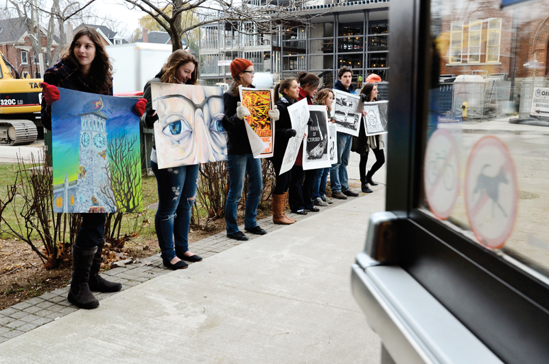 Fine Arts students congregrate outside the Robert Sutherland building on Tuesday to protest the recent decision to suspend admissions to the Fine Arts program.