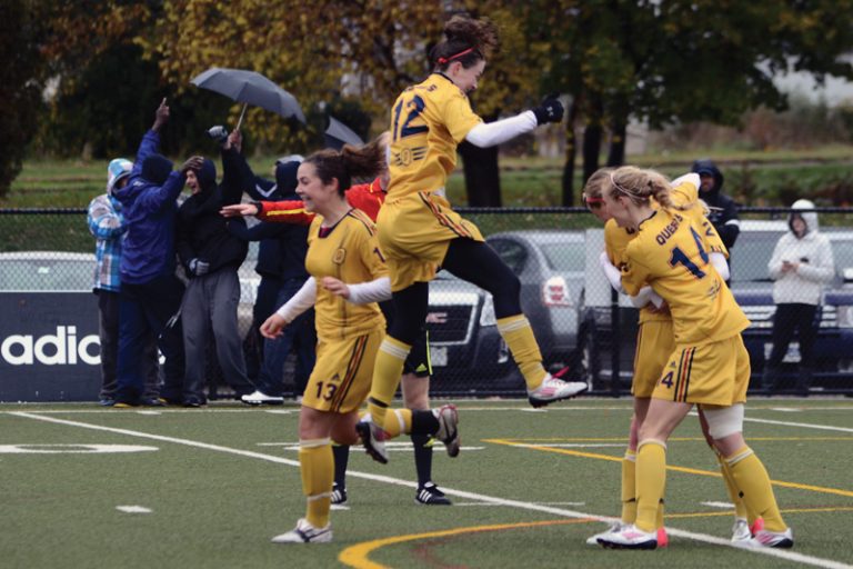 The women’s soccer team celebrates Alexis McKinty’s game-tying goal in the 88th minute against Toronto.