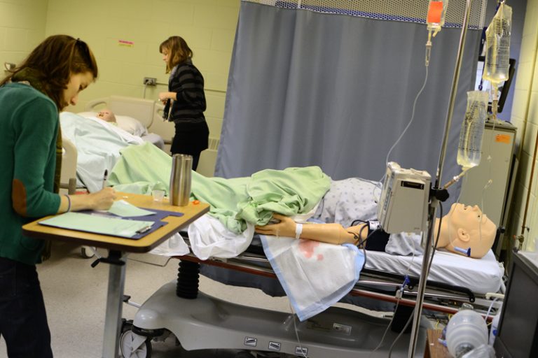 Students use a simulation dummy to educate themselves on dangers.