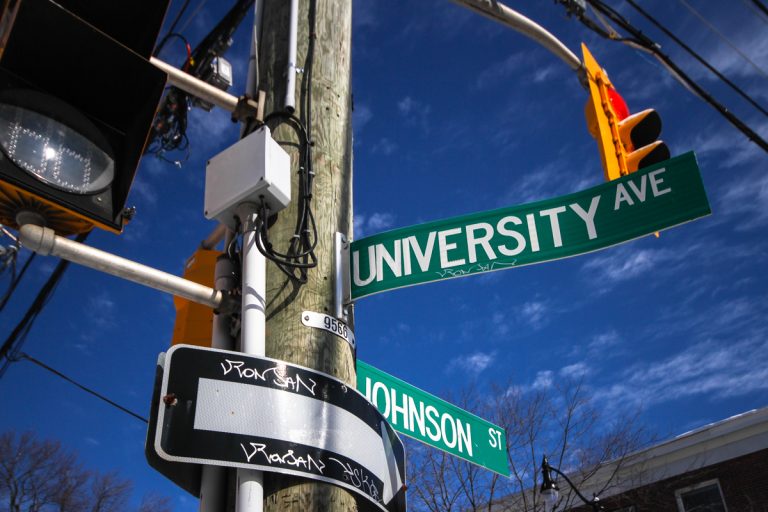 Decommissioned street signs from before the University District rebranding are being sold at auction.