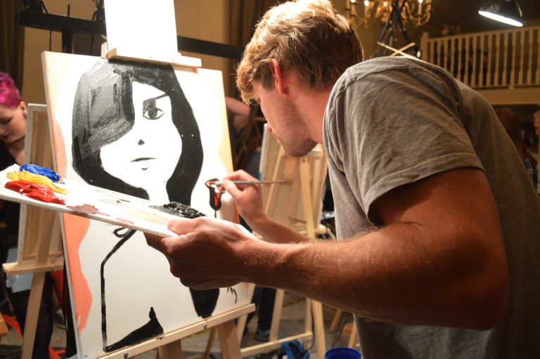 One art battle contestant paints under pressure.