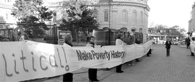 A crowd of 300 people wound a white banner around City Hall on Monday to protest poverty.