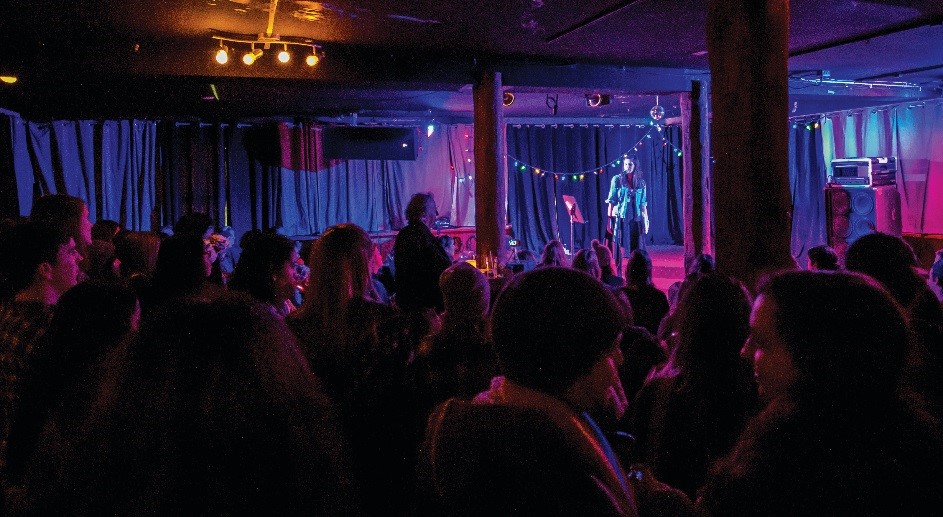 A crowd gathered in front of the stage at The Mansion