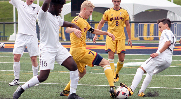 Jacob Schroeter shifts through a pair of Carleton defenders.