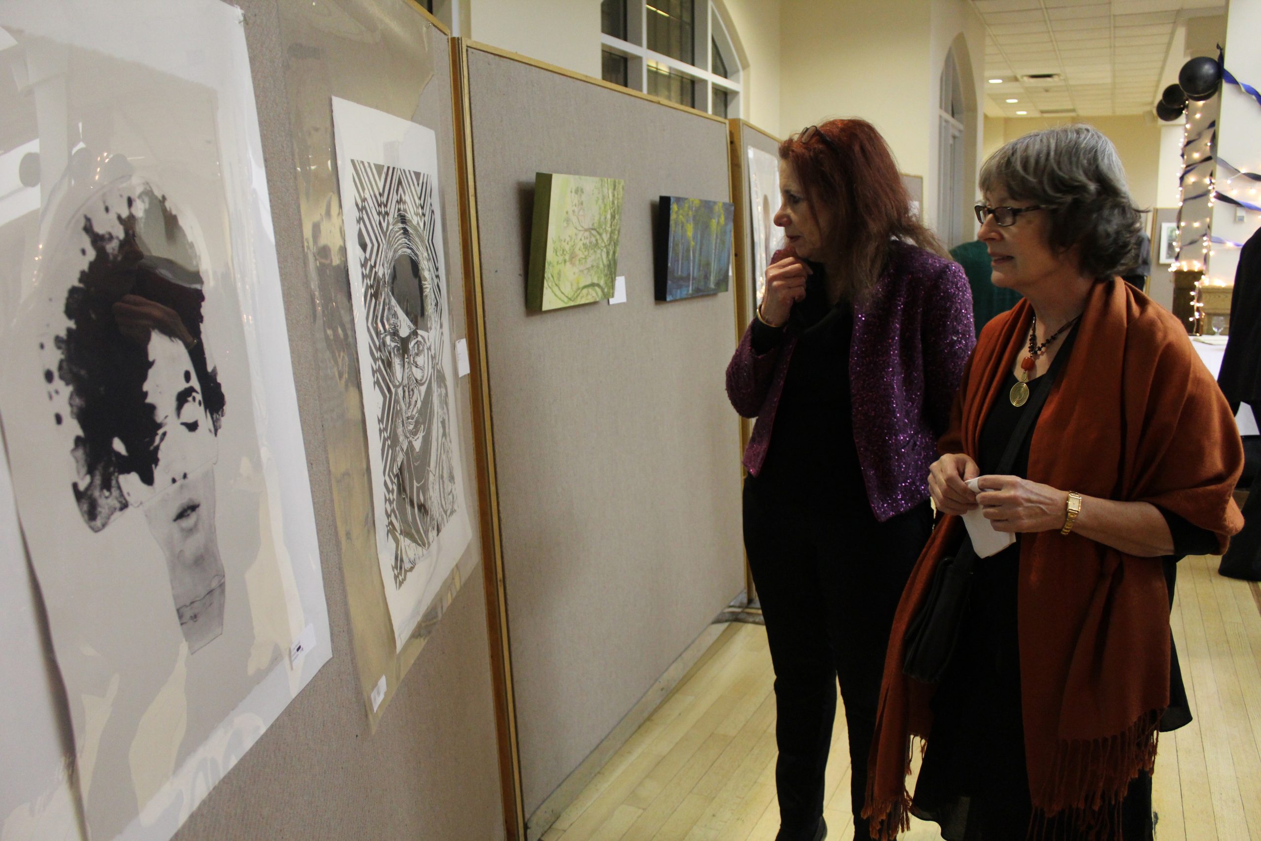 Guests admire the work on display at the event.