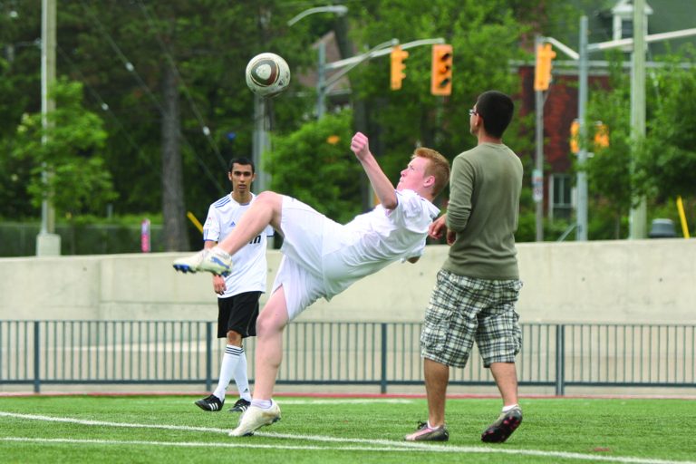 A summer intramural player attempts a bicycle kick during a game at Tindall field last week.