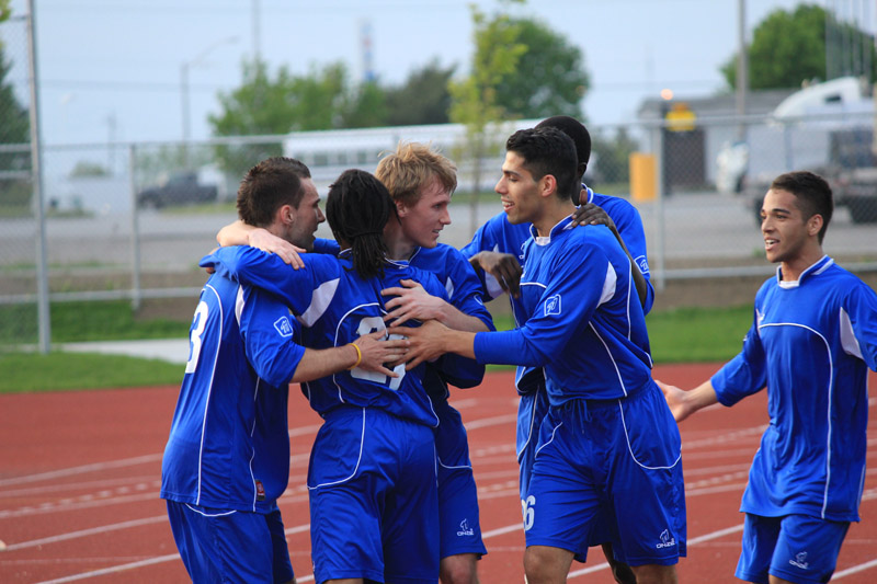 Jordan Brooks (third from left) celebrates with his Kingston FC teammates during their game against the York Region Shooters on May 12.