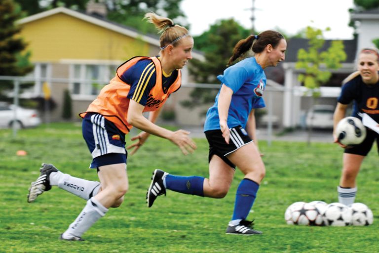Queen’s striker Jacqueline Tessier chases down a teammate during a Kingston FC training session.