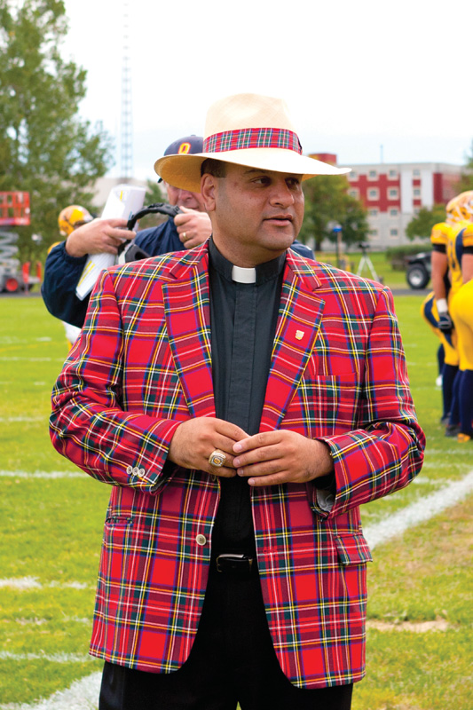 Father Raymond de Souza leads the football team in a prayer before every game.