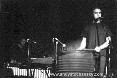 Andy Stochansky playing an oil drum.