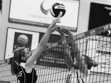 Annika Green (left) goes up for a block in the women’s straight-sets win over the Royal Military College Paladins Wednesday.