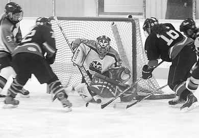 Becky Conroy (16) takes a shot against Brock Saturday as linemate Kelsey Thomson looks on.