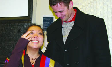 Former rector Grant Bishop presents rector-elect Johsa Manzanilla with the rector gown.