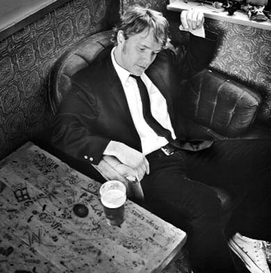 The dapper Doucet lounges in pensive thought.