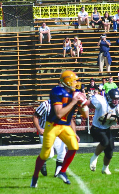 The stands sit empty during a regular season football game.