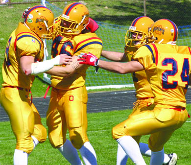 The Gaels defence celebrates a stop—in traditional gold—on Homecoming Saturday.