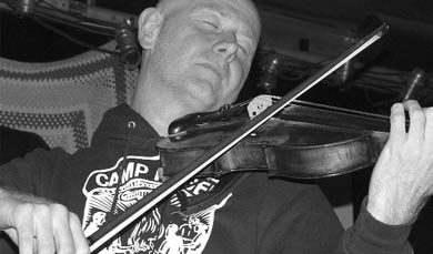 A member of the Toronto based Hidden Cameras fiddles with the ambience of the band’s set.