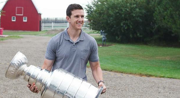 Ryan van Asten holds the Stanley Cups he won as part of the Los Angeles Kings organization.