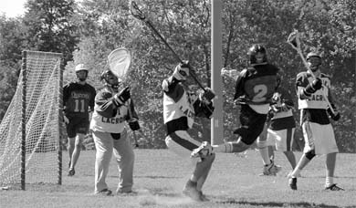 Christian Rice leaps to unleash a shot on his way to a hat trick against Laurier on Saturday. The Gaels won 10-4.