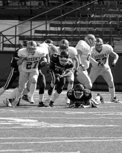 Tailback Marty Gordon (27) escapes McMaster defenders.