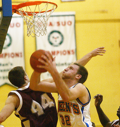 Men’s basketball forward Mitch Leger tries for a layup against Ottawa centre Dax Dessureault Tuesday. The Gaels lost 74-70.