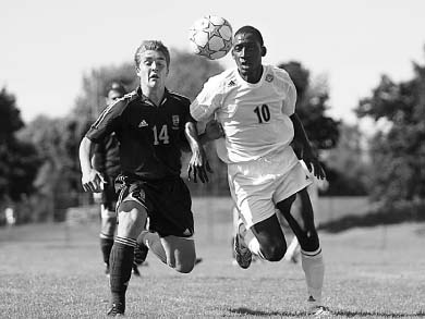 Mike Arnold (14) chases the ball in the Gaels’ game against Nipissing Sunday.
