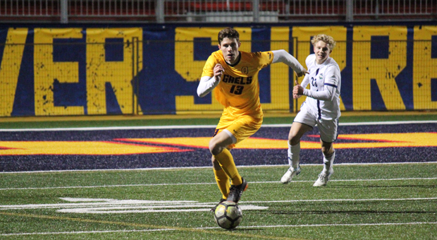 Second-year defender James Michaelis sprints up the field with the ball.