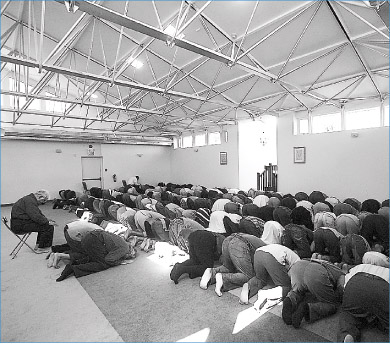 Muslims pray facing east during Friday prayers at the Islamic Society.