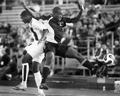 Canadian defender Nana Attakora-Gyan (2) and American midfielder Anthony Wallace battle for position in the June 6 match.