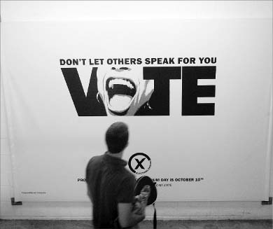 Students pass a sign in the PEC encouraging them to vote. The Ontario general election takes place on Oct. 10.