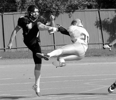 Queen’s narrowly misses a punt block attempt en route to a 26-18 win over Waterloo.