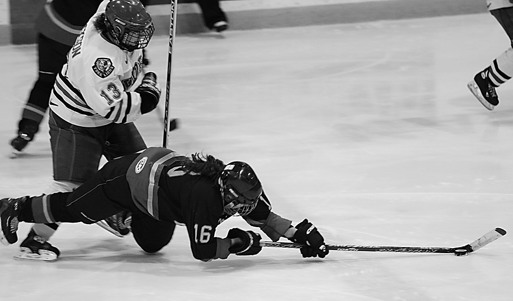 Queen’s forward Becky Conroy is tripped by York’s Justine Jackson in Feb. 16’s quarter-final.