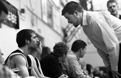Queen’s point guard Baris Ondul gets an earful from assistant coach Duncan Cowan Saturday.