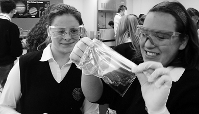 Regiopolis Notre Dame Catholic Secondary School students Tanya Whan (left) and Alexis Amaral participate in a slime-making activity as part of Queen’s Let’s Talk Science partnership program.