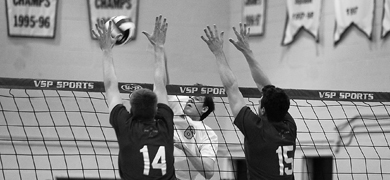 Rookie left side hitter Bryan Fautley (6) goes up for a kill against David Gomes (14) of the Royal Military College Paladins Wednesday night. The Gaels won 3-1.