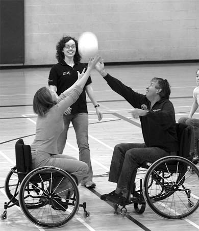 Stefanie Reid of Paralympics Ontario throws up a jump ball during wheelchair basketball.