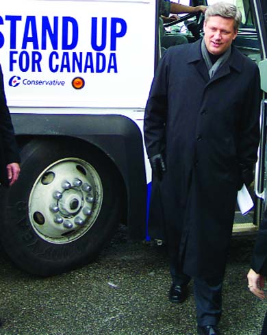 Stephen Harper struts out of his Tory-mobile.