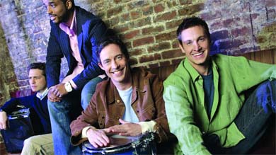Queen’s alum Tom Cavanagh (centre) stars as Tom Farrell in the new CBS show Love Monkey
