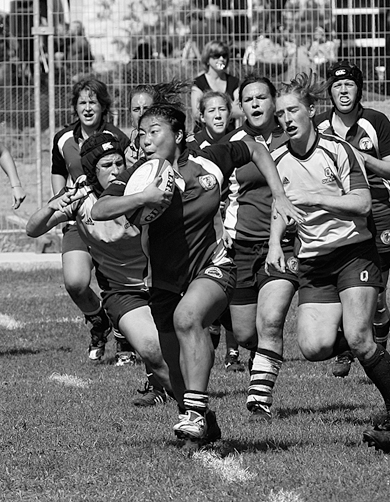 Gaels Jocelyn Poirier (left) and Emily Stern track down Varsity Blues’ inside centre Jenny So Sept. 20. Queen’s won that game