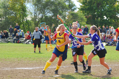 Queen’s Carley Miller avoids a stick lift from Western’s Adrianna Clapp Saturday.